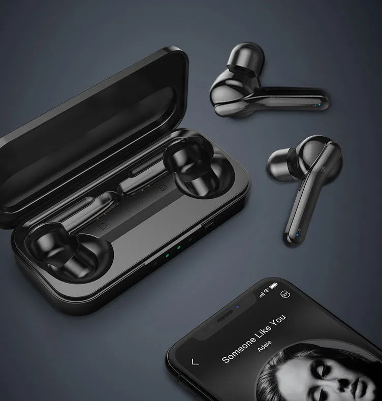 Black and white true wireless earbuds with charging case on a table, showing compact design.