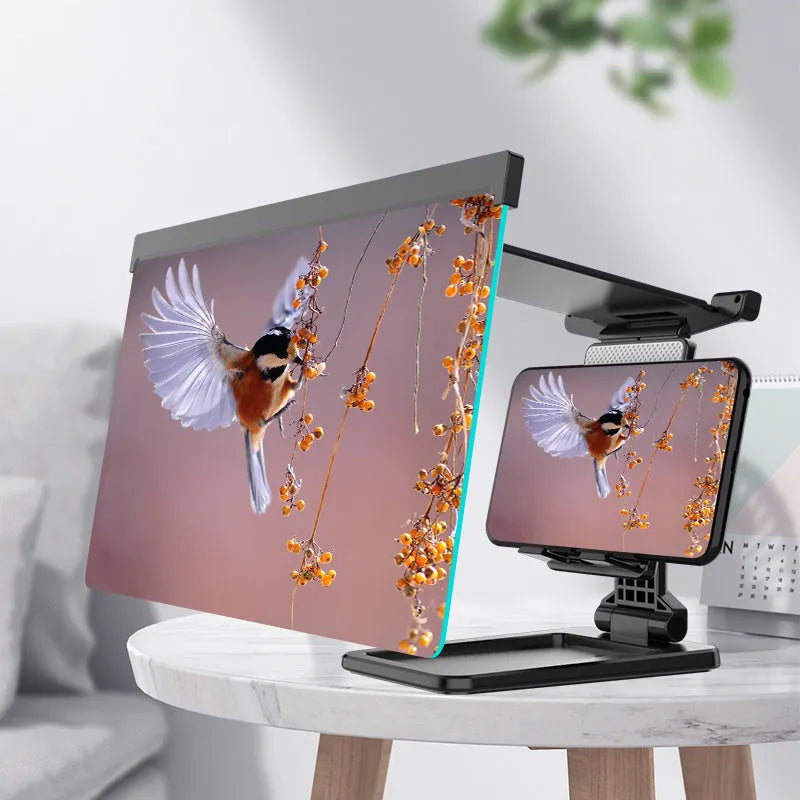 Black folding mobile phone screen magnifier and adjustable holder on a desktop.