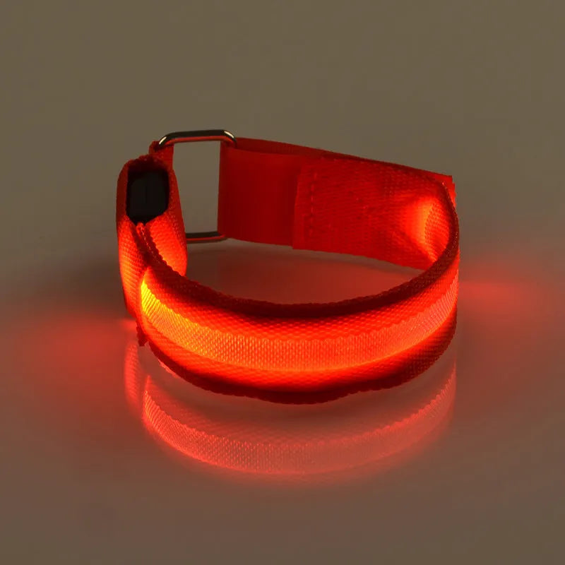 Illuminated arm band with LED lights on a black ribbon, adjustable, showing blue and red colours