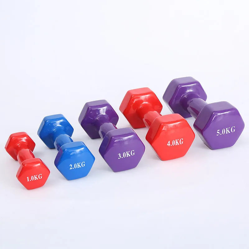 Set of bright coloured plastic fitness dumbbells showing 0.5kg, 1kg, and 1.5kg weights on a floor.