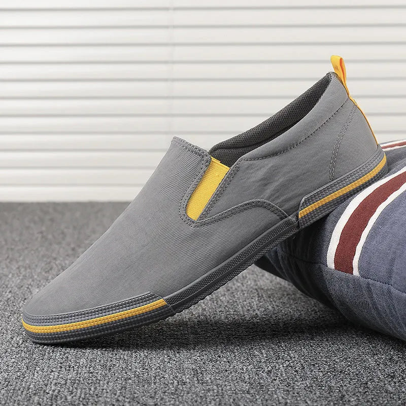 Men's casual canvas sneakers in grey, black orange, and khaki with vulcanised rubber soles
