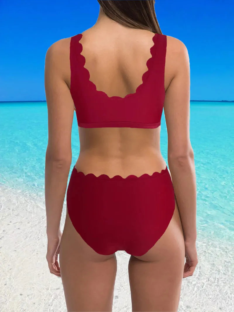 Red high-waisted women's two-piece swimsuit with a gathering split detail on a mannequin.