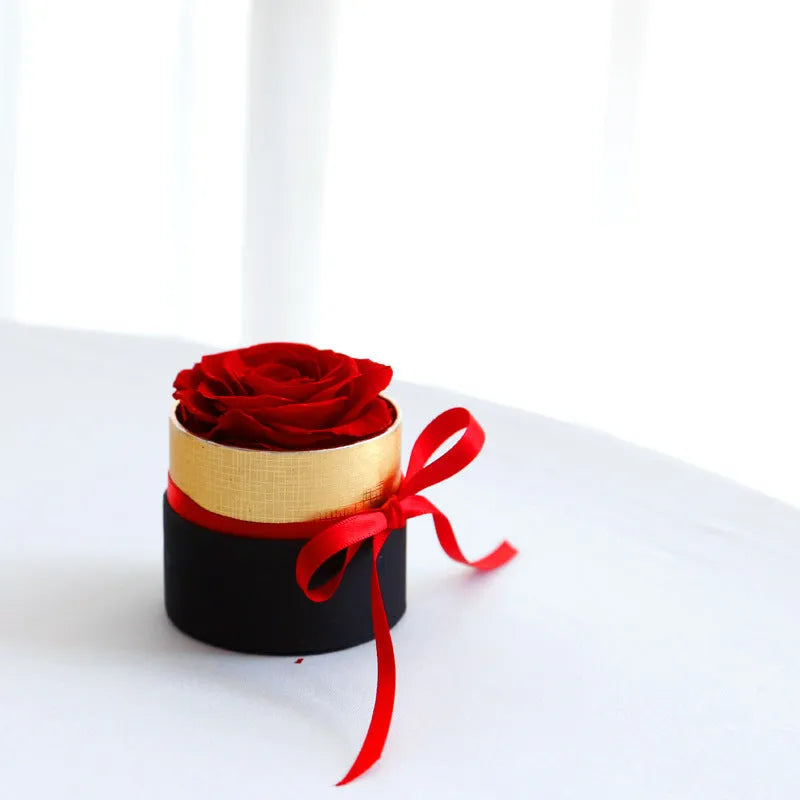 Luxury gift box open to display preserved real red roses, a Valentine's Day gift set.