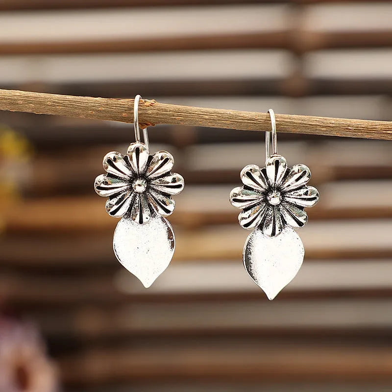 Silver alloy clip-on earrings with artificial gemstone inlays, vintage floral style, sold as a pair