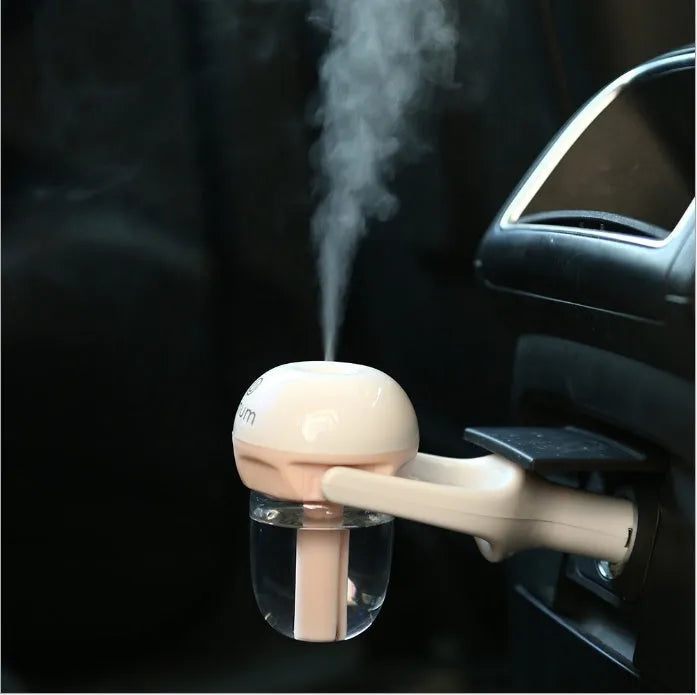 Compact portable car humidifier and essential oil diffuser unit in blue, green, pink, or purple.