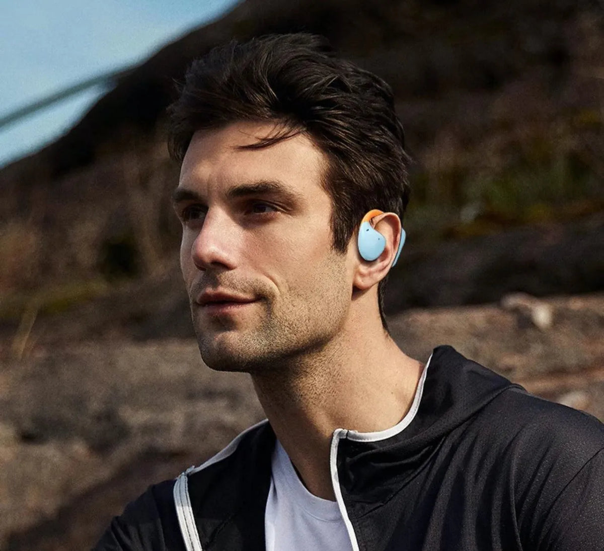 Non in-ear Bluetooth headset in blue orange or black orange with 15 metre range and 4-8 hour battery life