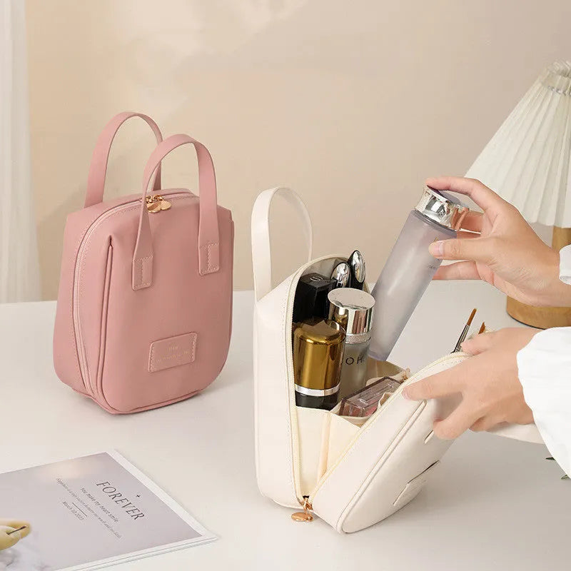 Shell-shaped handle-top cosmetic bag in cream white, PU material, 20x16x8 cm, for travel make-up storage