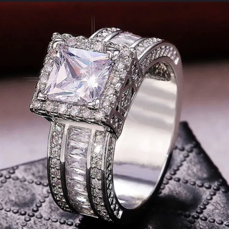 Geometric round women's alloy ring on a hand, showing angular design in gold or white electroplated finish.