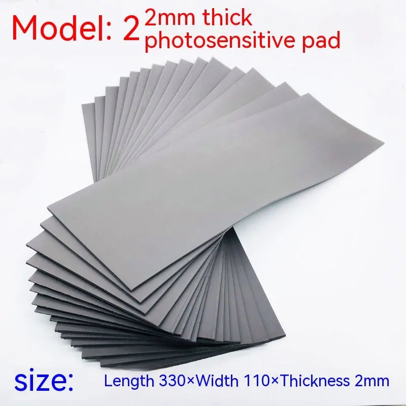 Black and grey plastic light-sensitive mat for seal making, showing 2mm, 4mm, and 7mm thickness options.