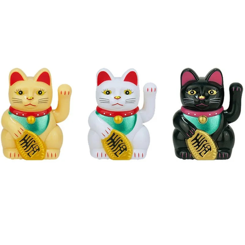 Small yellow solar powered Maneki Neko lucky cat decoration waving its arm.