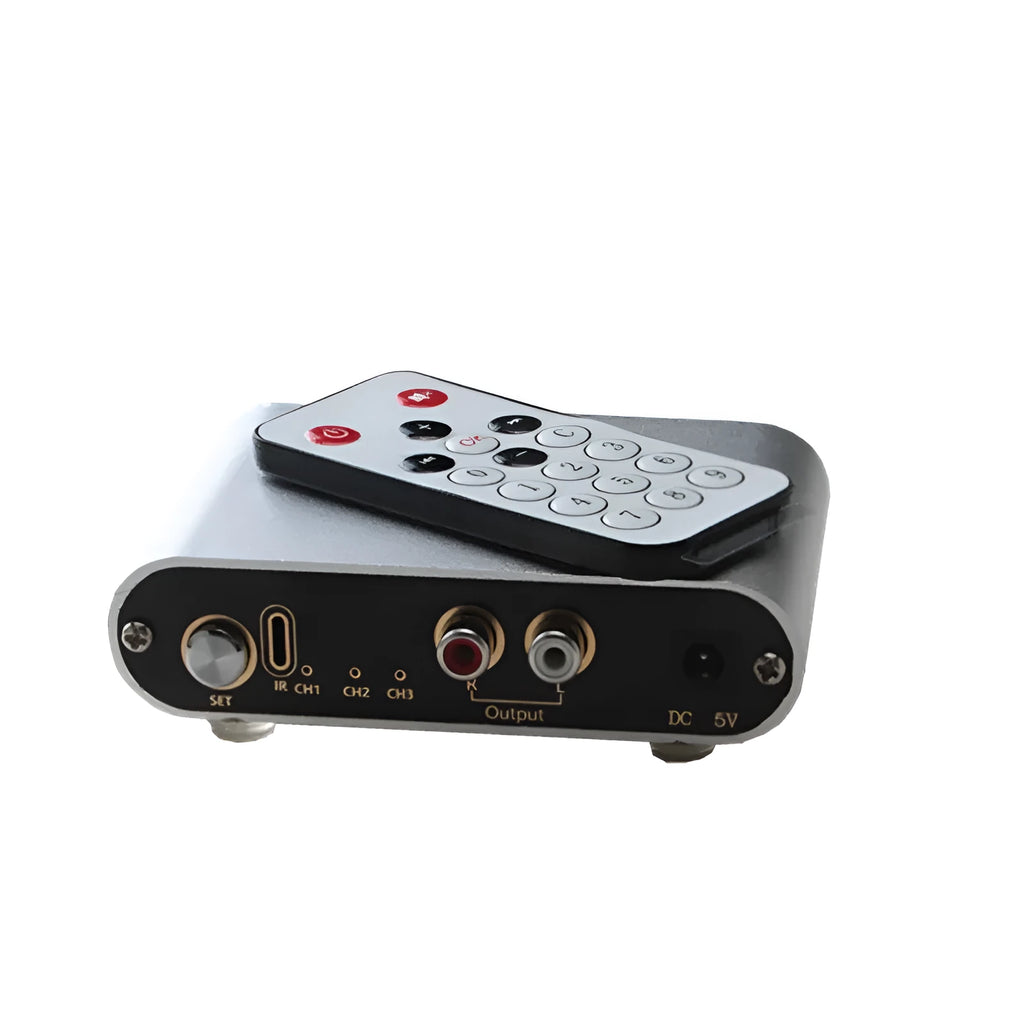 Silver aluminium audio source selector switch unit with front panel button and infrared remote.