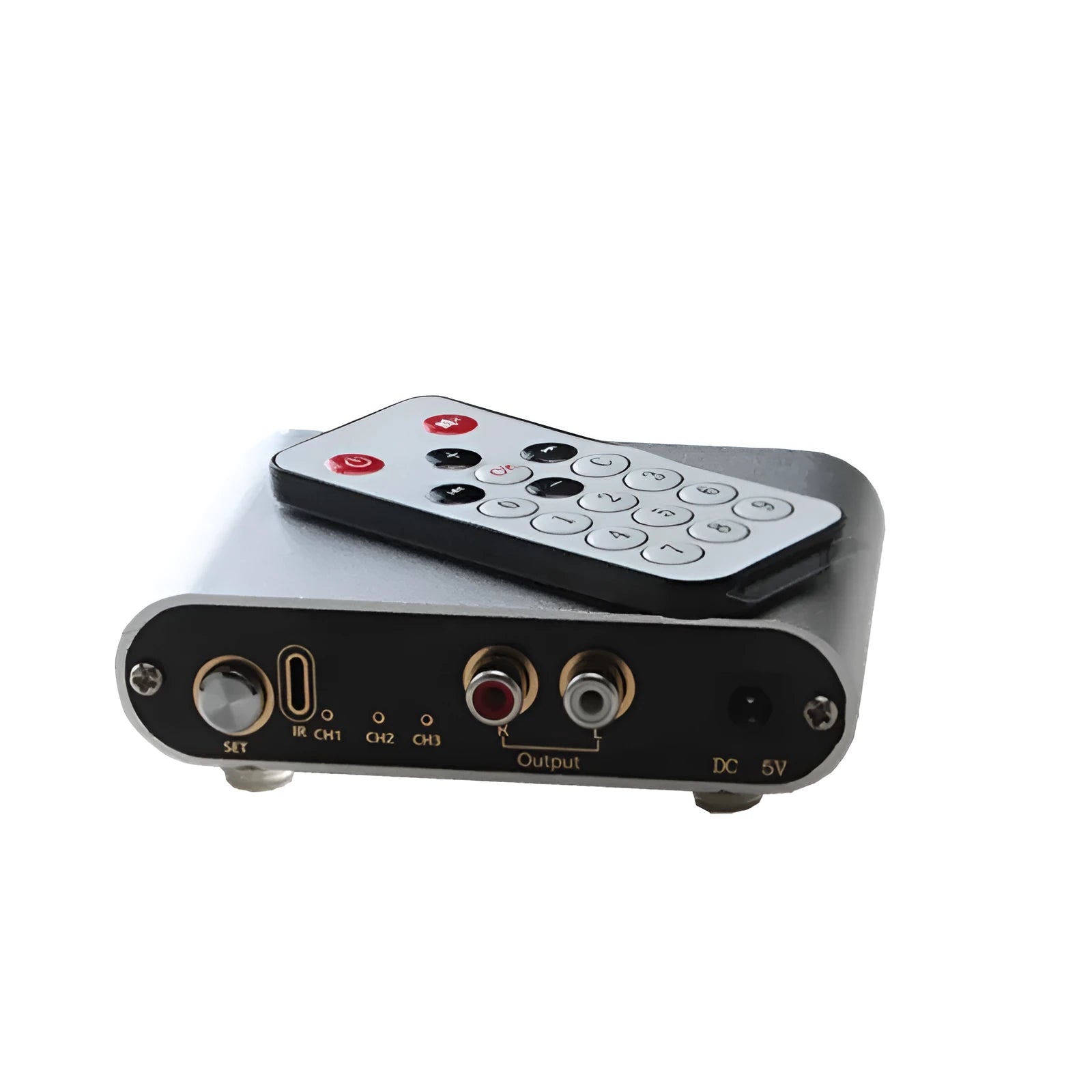 Silver aluminium audio source selector switch unit with front panel button and infrared remote.