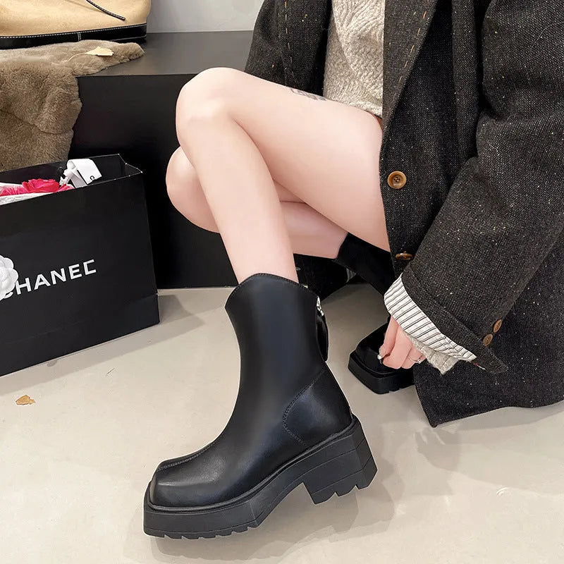 Black square toe platform Martin boots for women with a back zipper and a mid-calf height.