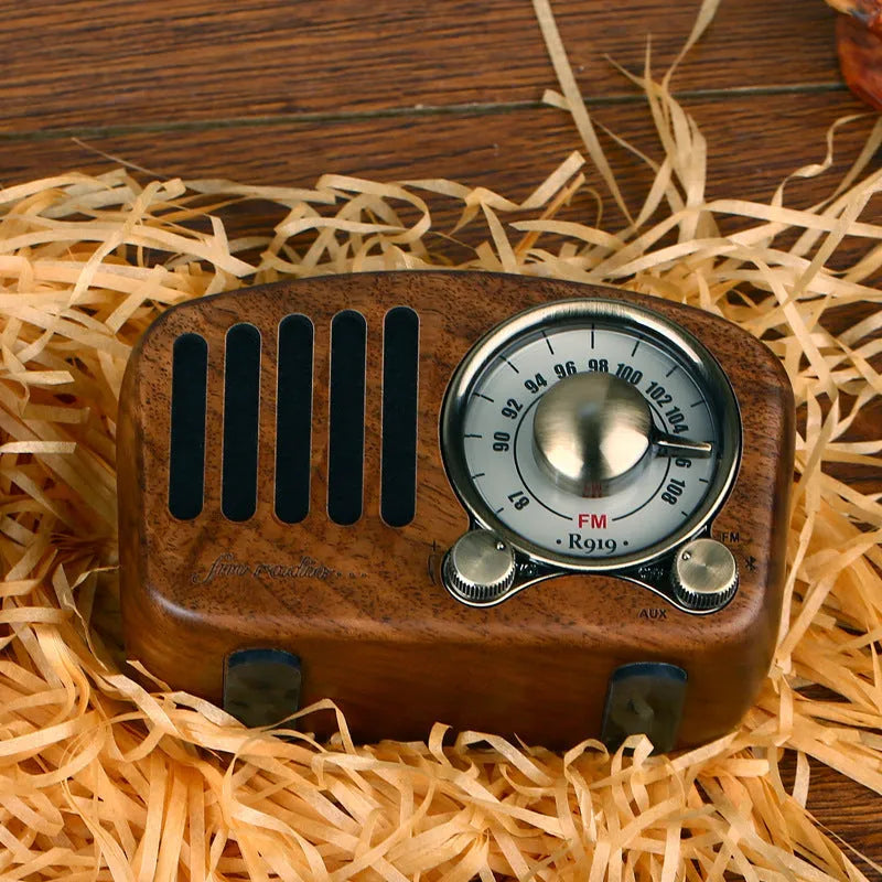 Retro wooden wireless mini speaker in cherry wood finish showing compact size.