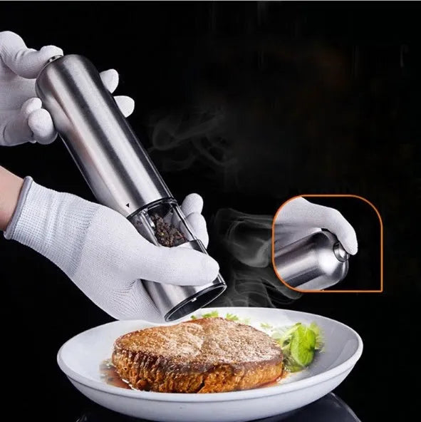Stainless steel electric pepper grinder on kitchen counter