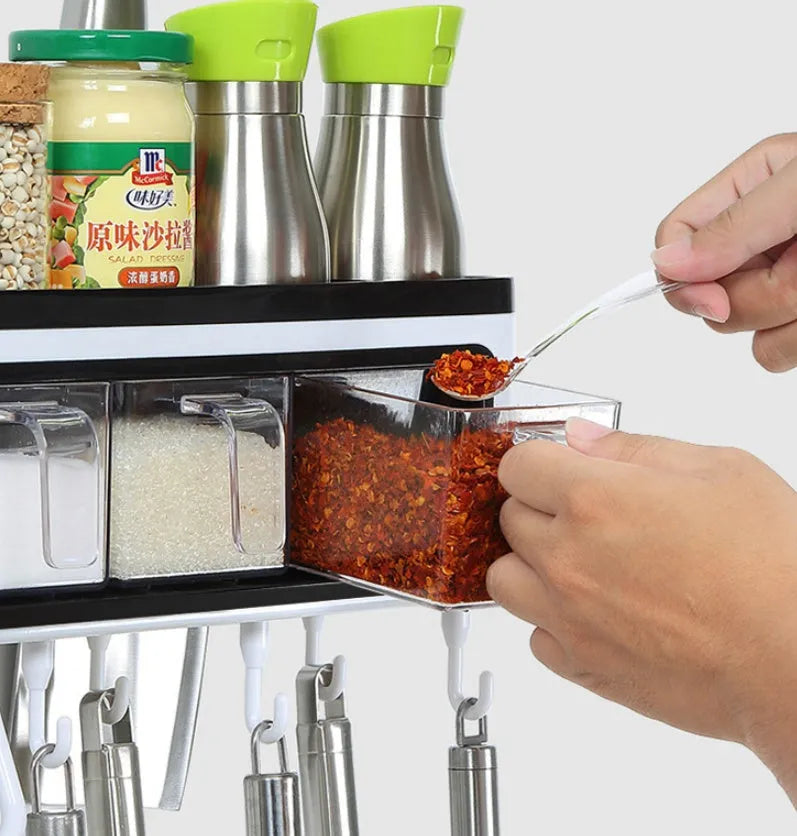 White plastic multi-function wall-mounted kitchen storage rack holding utensils and seasoning bottles