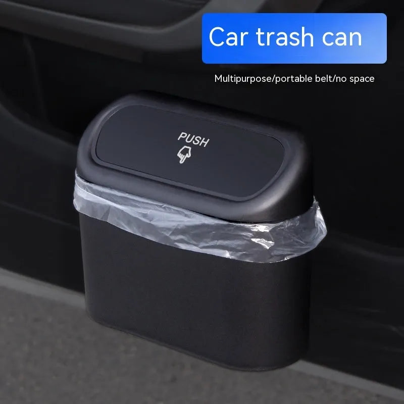 Black plastic folding car trash can placed between vehicle seats.