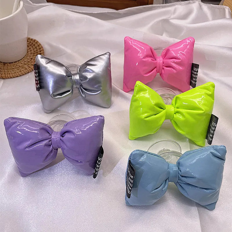 Girl's leather bow lazy bracket with transparent support in black, shown on a plain background