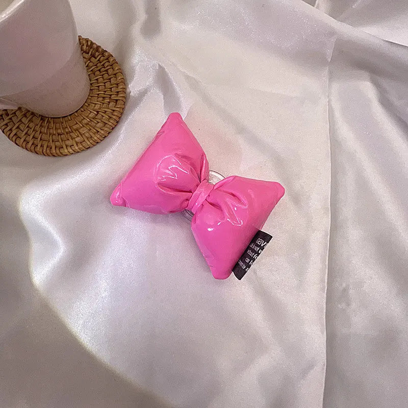 Girl's leather bow lazy bracket with transparent support in black, shown on a plain background
