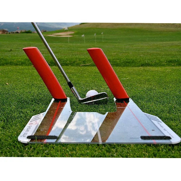Red plastic putting practice mirror for golf training aid on green surface