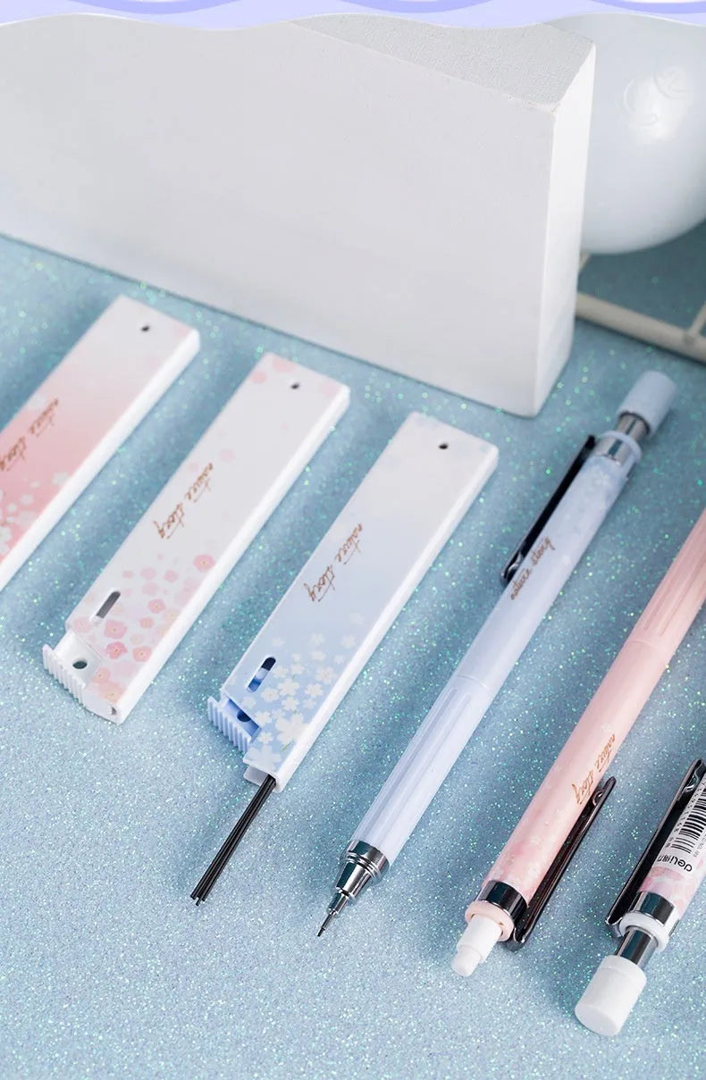 Cartoon sakura design automatic pencil set with three pencils and boxes of HB refills.