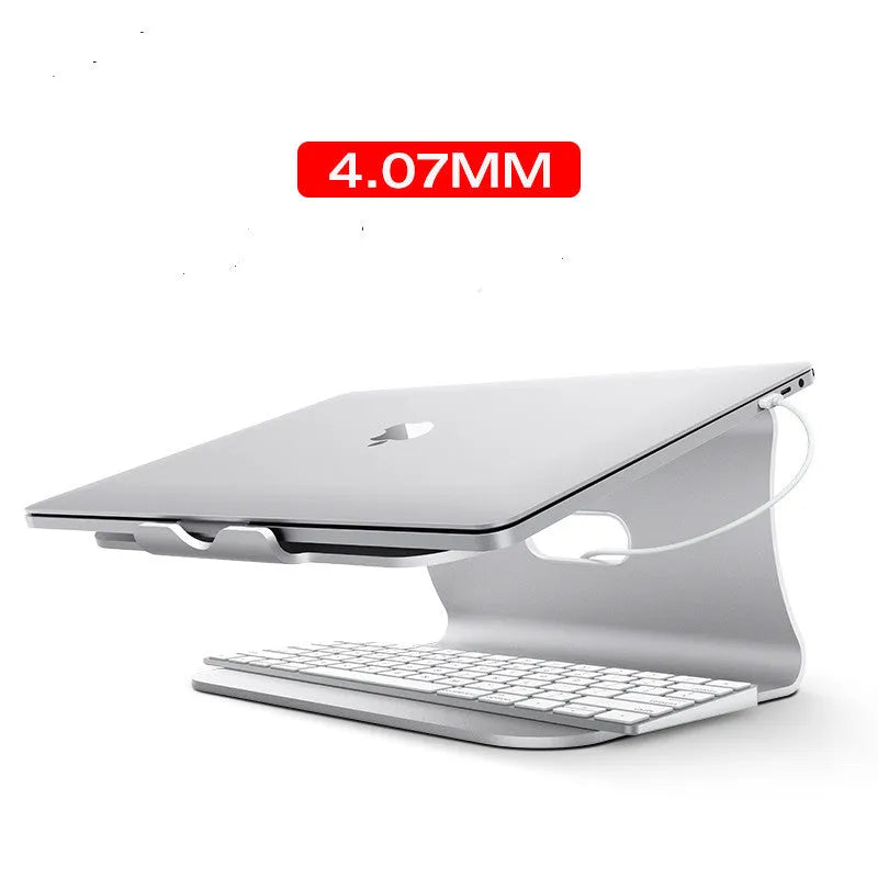 Silver aluminium laptop cooling stand with striped texture and 360-degree rotating base on a wooden desk.