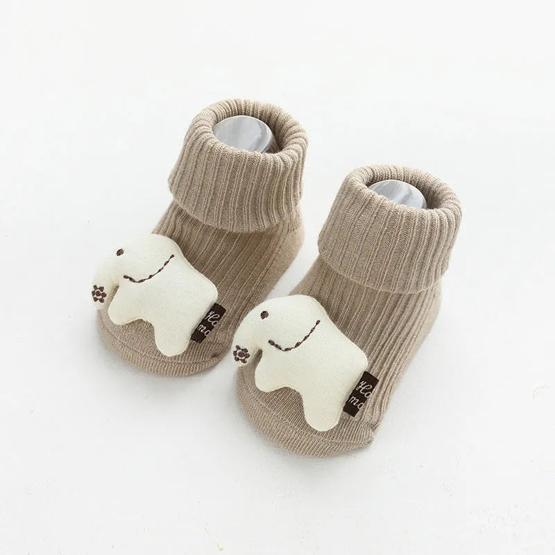 Pair of light grey baby socks with white non-slip silicone grip dots on the soles.