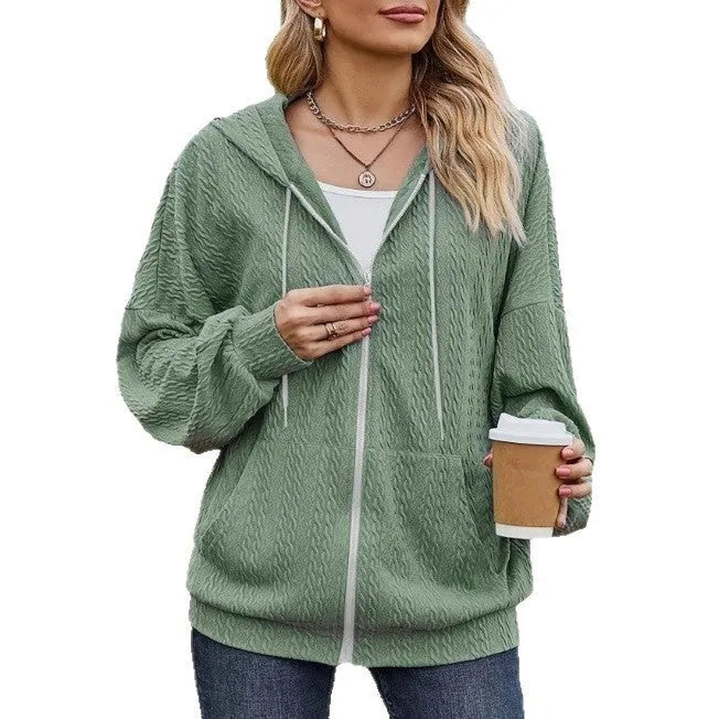 Forest green women's loose-fit hooded zip-up sweater coat on a hanger, showing front zip and long sleeves.