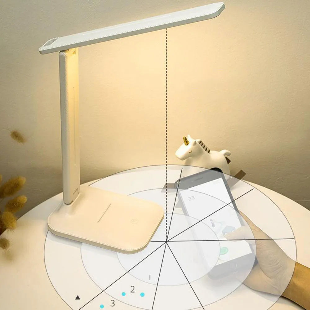 White USB rechargeable bedside lamp with touch dimming controls on a table.