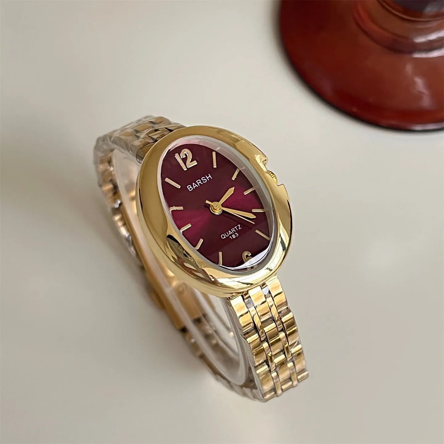 Oval alloy ladies watch with gold strap and choice of white gold or red dial face stainless steel back