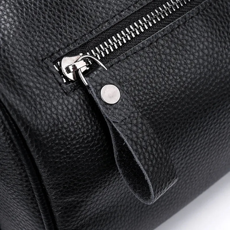 Black genuine leather one-shoulder crossbody bag showing front and interior with polyester lining