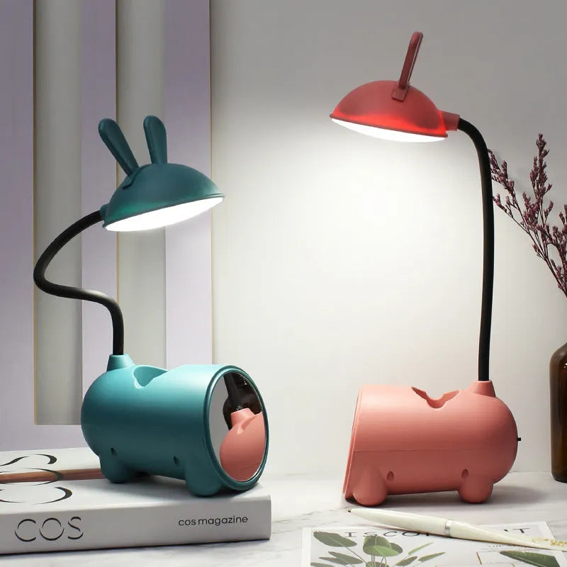 Cartoon-themed plastic desk lamp with USB power and pen storage compartment in dark blue colour