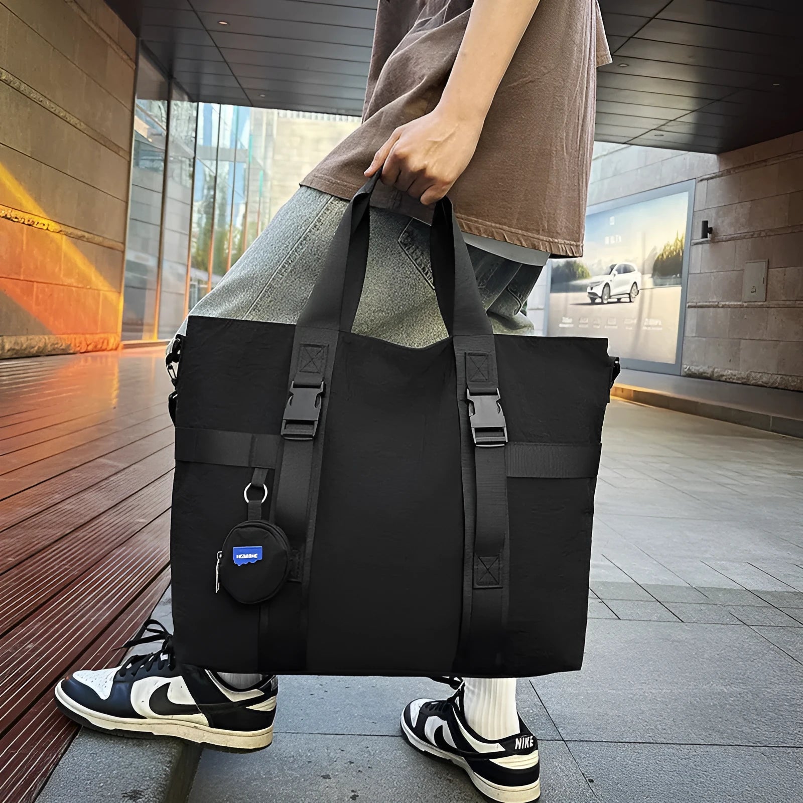 Men's large capacity shoulder travel bag in black colour with organisational compartments