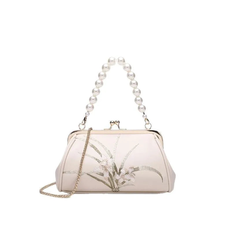 Beige women's shoulder bag with embroidery detail and shell-shaped design in soft PU leather