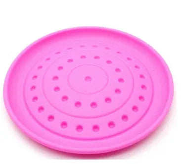 Plastic dog frisbee disc in green colour for outdoor fetch play with a dog.