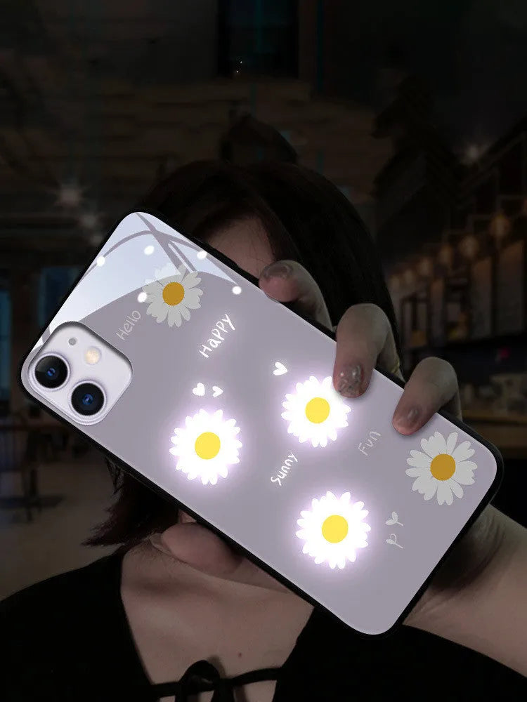 White iPhone case with painted daisies and a voice-activated coloured light strip on the back.