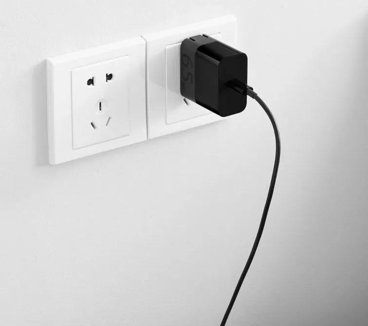 Black ZMI USB-C 65W notebook power adapter showing compact size