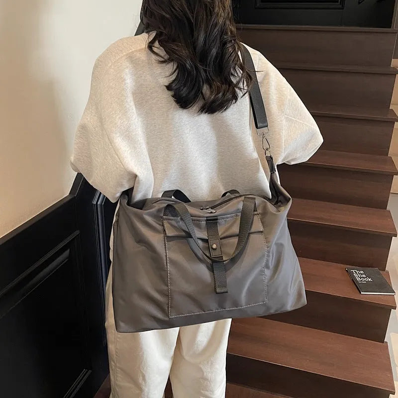 Grey one-shoulder travel backpack with 55 litre capacity showing Oxford cloth construction