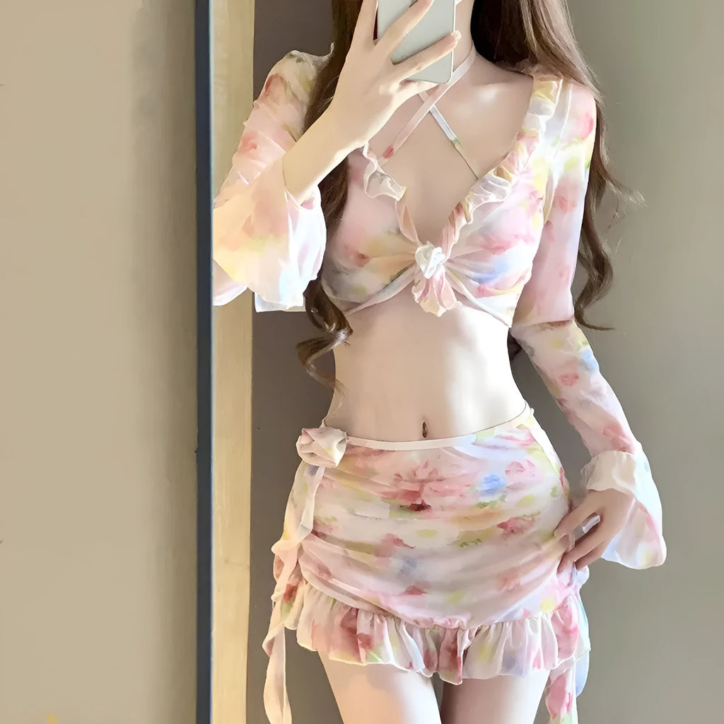 Women's cherry blossom pink floral print bikini swimsuit set laid flat.