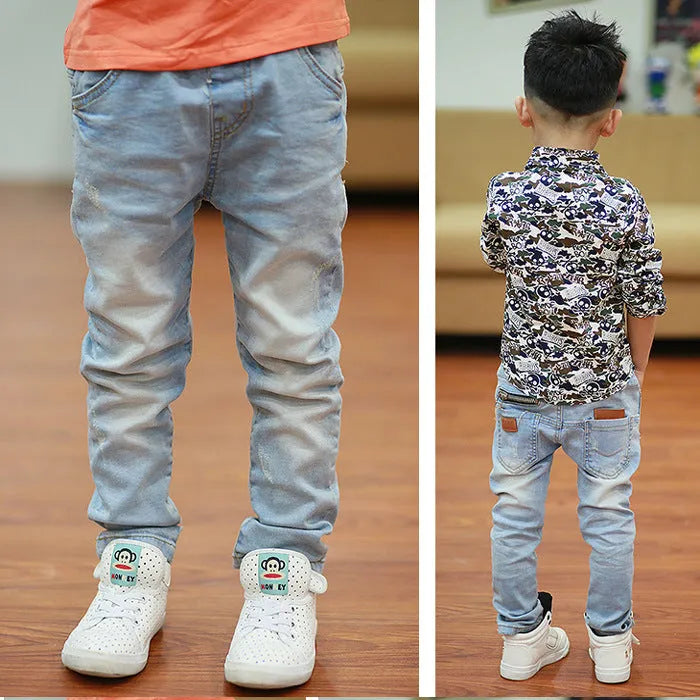 Boys' striped denim harem trousers with an elasticated waistband on a hanger.