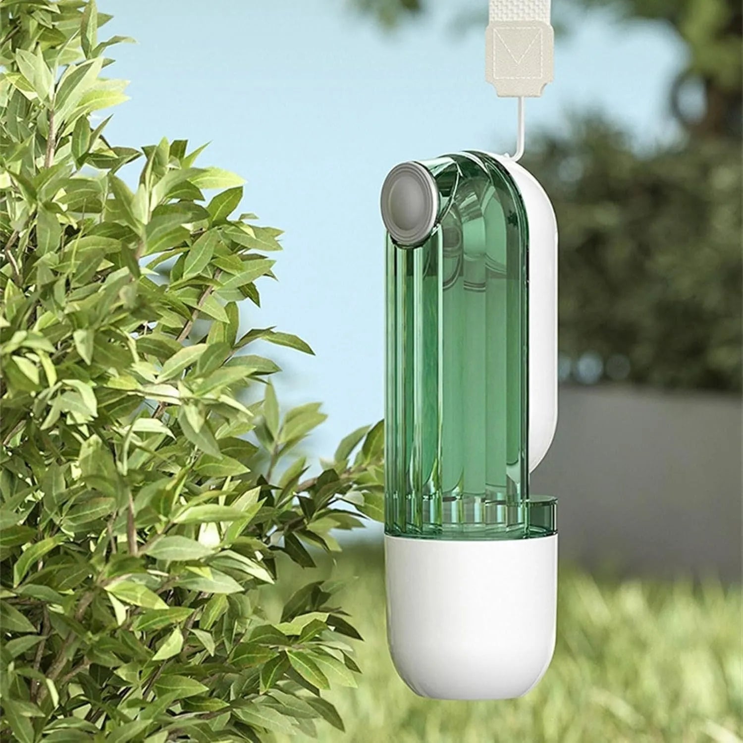 Beige foldable dog water bottle and food dispenser with large drinking opening, shown next to a leash.