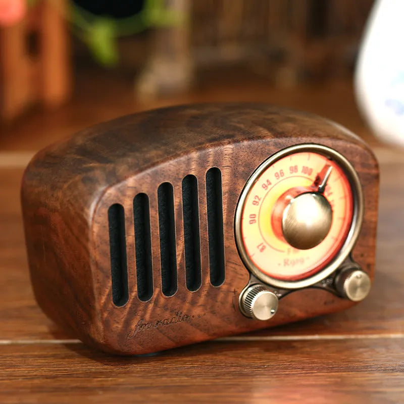 Retro wooden wireless mini speaker in cherry wood finish showing compact size.