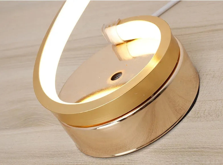 Gold 24W LED table lamp with curved metal base and acrylic shade, remote control, 125mm x 450mm