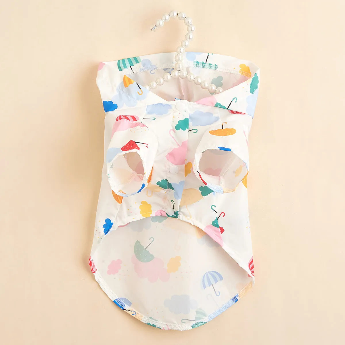 Colourful cartoon umbrella pattern dog or cat raincoat made from polyester fabric.