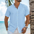 Man wearing a light blue cotton linen blend cardigan shirt with a henry collar and short sleeves.