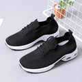 Women's black lace-up casual sneakers with a mesh upper and a textured non-slip PVC sole.