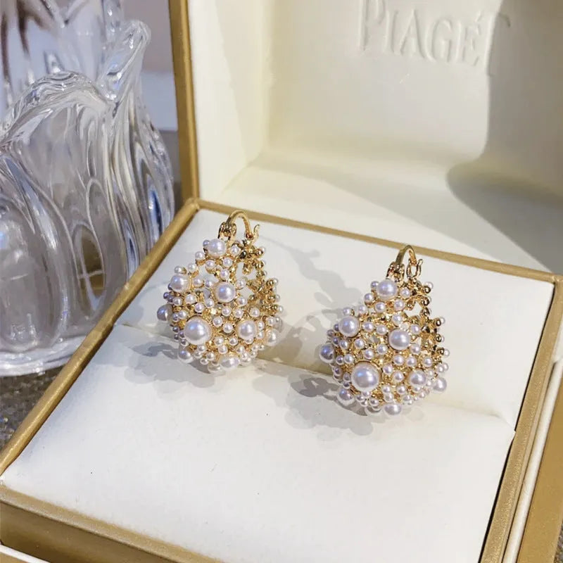 Gold women's earrings with flower basket design and small rice-shaped beads