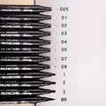Set of black comic drawing pens with multiple nib sizes in a storage bag organiser.