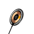 Round 15W magnetic wireless charger disc in white, black, and transparent finishes on a desk