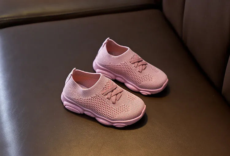 Children's lazy slip-on shoes in fabric with non-slip rubber sole, shown in available colours.